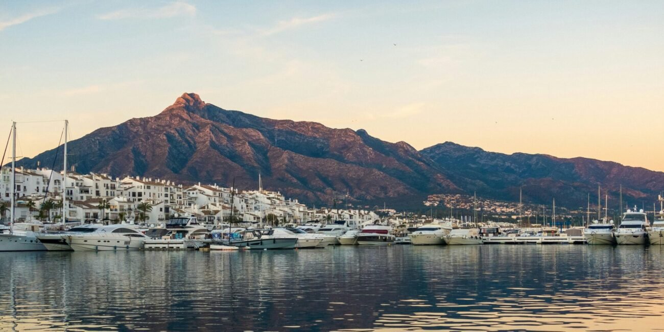 white boats on sea near mountain during daytime